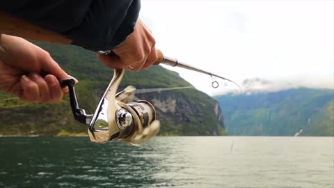 woman fishing on fishing rod spinning in norway