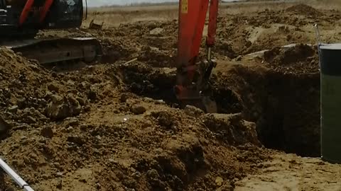 The excavator works with a frozen ground with a special bucket.