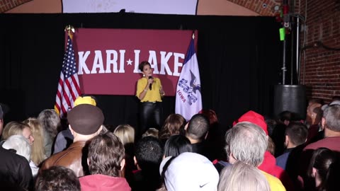 Kari Lake speaks to a crowd in Iowa City