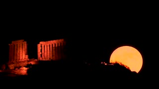 Drone shows 'strawberry' supermoon behind ancient Greek temple