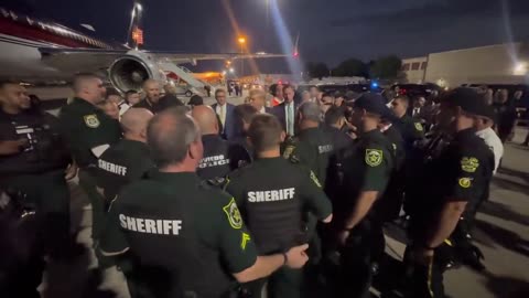 Law enforcement lines up to pose with Trump