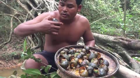 Primitive Man Entering the Forest and Collecting African Snails and Eating