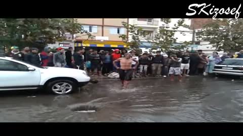 A man open drains to avoid flooding