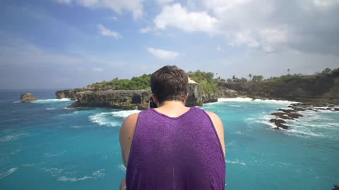 Man Taking a Photo of Bali Coastline