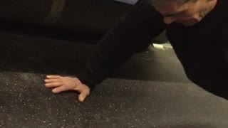 Man does push ups on subway floor