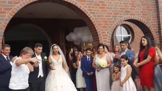 Angle 2 bride and groom release bird bird falls onto floor wedding