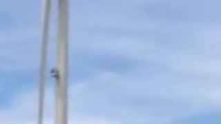 Dangling Windmill Worker Hangs High Above Ground