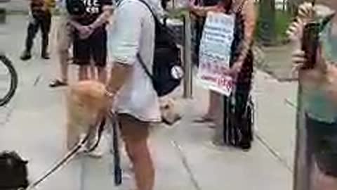 Adults trying to protect children from the experimental poison injection while police block the way