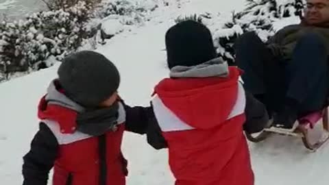 Kids pull dad in sleigh in Poland