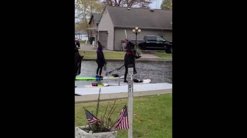 Women dressed as witches switch brooms for paddleboards on Halloween ride down US river