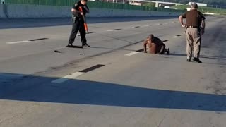 Police Approach Man in Underwear on Highway