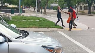 Girl Uses Hockey Stick to Strike Protesters