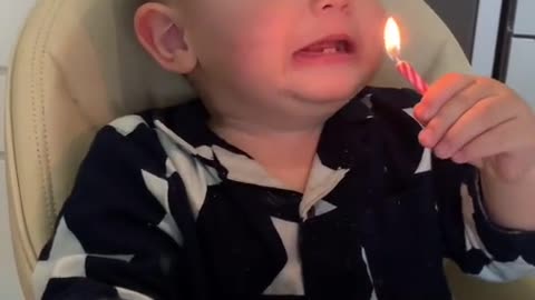 Very funny boy singing and blowing out candles