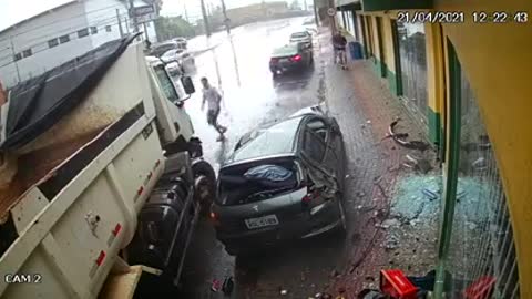 truck crashes into car stopped in parking lot