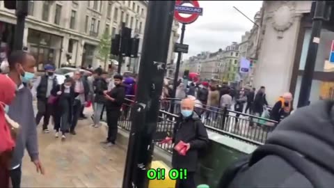 A British man walks up to a group of masked anti-Israel protesters