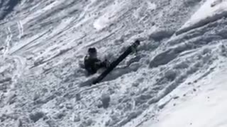 Guy back flips off small ledge on skis and lands face first into snow