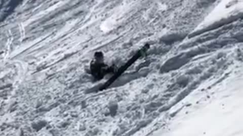 Guy back flips off small ledge on skis and lands face first into snow