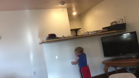 Toddler chases light like a cat