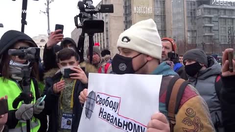 Moscow protester surrounded by reporters demands release of Alexei Navalny