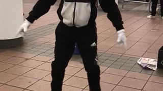Guy black outfit white mask dancing on woman