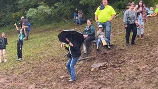 Woman Slips on Muddy Slope