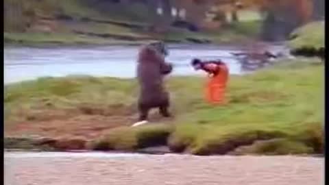 man fights bear for fish