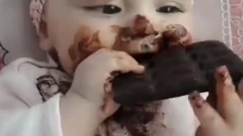 Cute baby eating chocolate