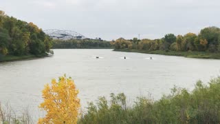 Boat & 2 water scooters are racing on Red river in early fall