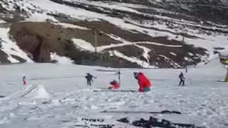 Guy blue jacket red pants ski backflip fail