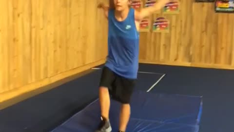 Kid does back flip spin on safety mat and lands on face