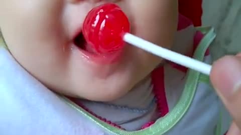 Baby eating candy is cute and funny