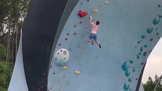 Man free climbs and falls into pool
