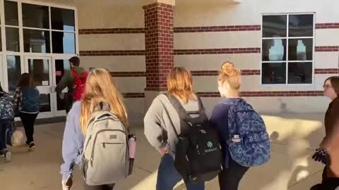 Students at Woodgrove High School in Loudoun County, Virginia walk into school without masks