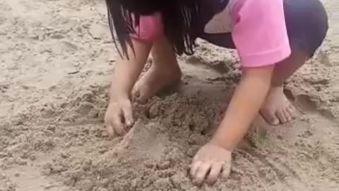 Sweet girl playing in the mud