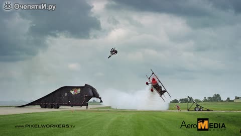 Motorcyclist jumping over an airplane