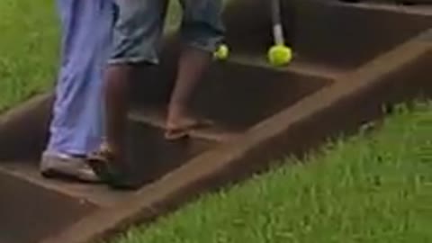 Boy helps elderly woman up stairs