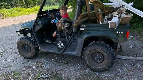 Grandson using Rhino to move debris