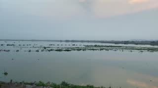 A river with an ancient bridge in Burma