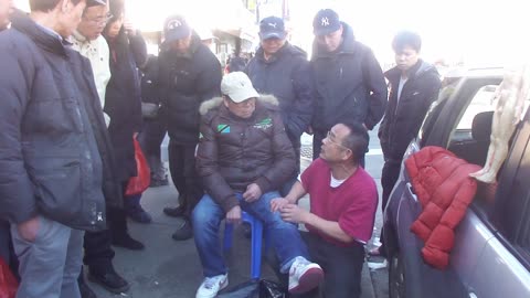 Luodong Briefly Massages Elderly Chinese Man's Leg On Sidewalk