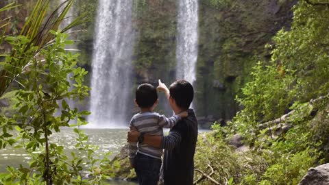 They watched the father explain to his son about nature and the waterfall