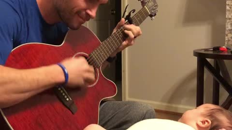 Dad plays beautiful guitar cover for captivated baby