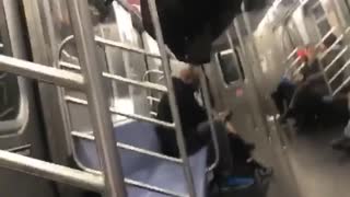 Girl black jacket upside down on bar subway train