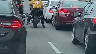 Angry Motorcyclist Kicks Swerving Car
