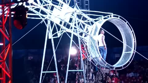 Guy jump ropes on balance beam and almost falls