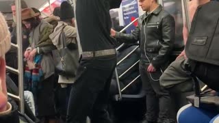 Contortionist guy bends his arms backwards and dances on subway train