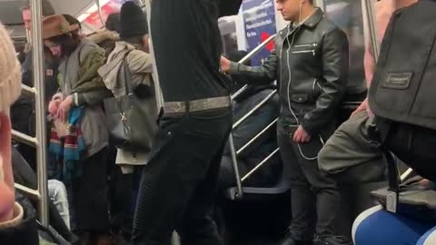 Contortionist guy bends his arms backwards and dances on subway train