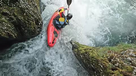 SLO -MO Rider in a yellow whitewater kayak dropping a waterfall stock video