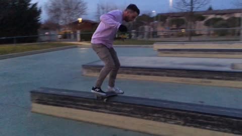 Guy in pink shirt face plants onto a skateboard