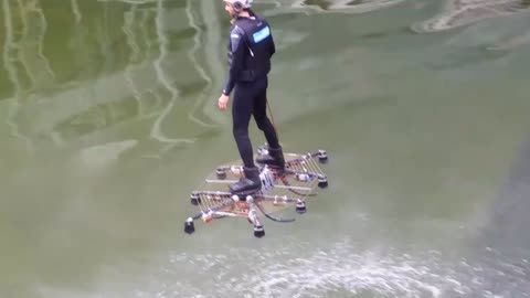 The man can fly on the water with hoverboard