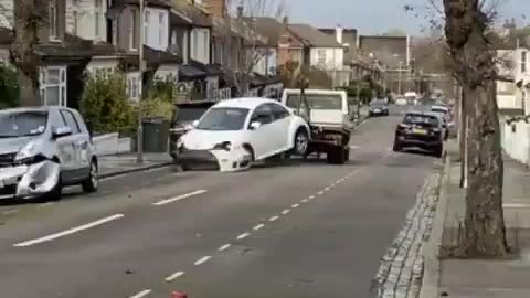 Tow truck driver smashes VW Beetle into FOUR parked cars on a London street